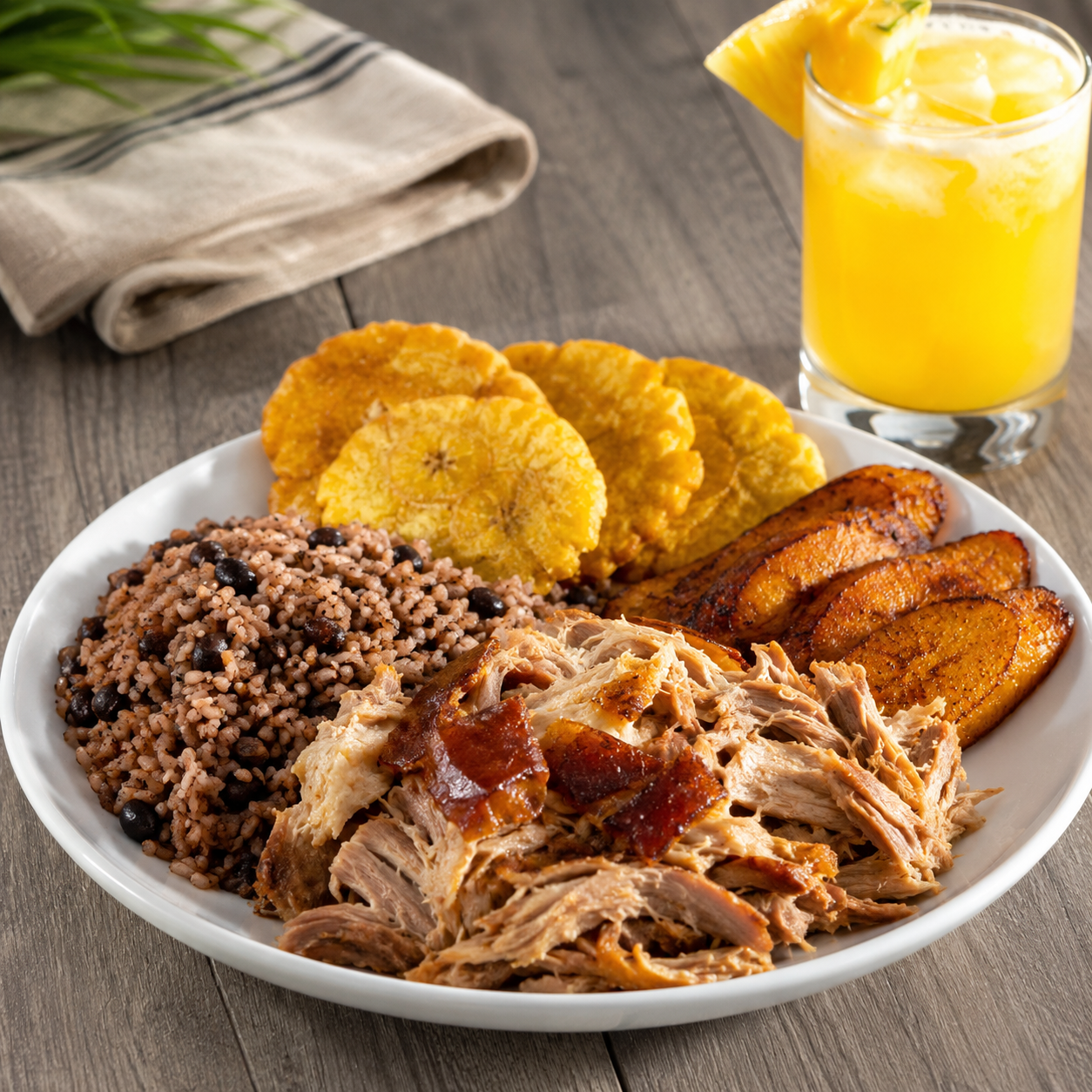 Pernil, rice, tostones, sweet plantains, and a tropical house-made drink at The Dominican Spot in Lake Worth Beach